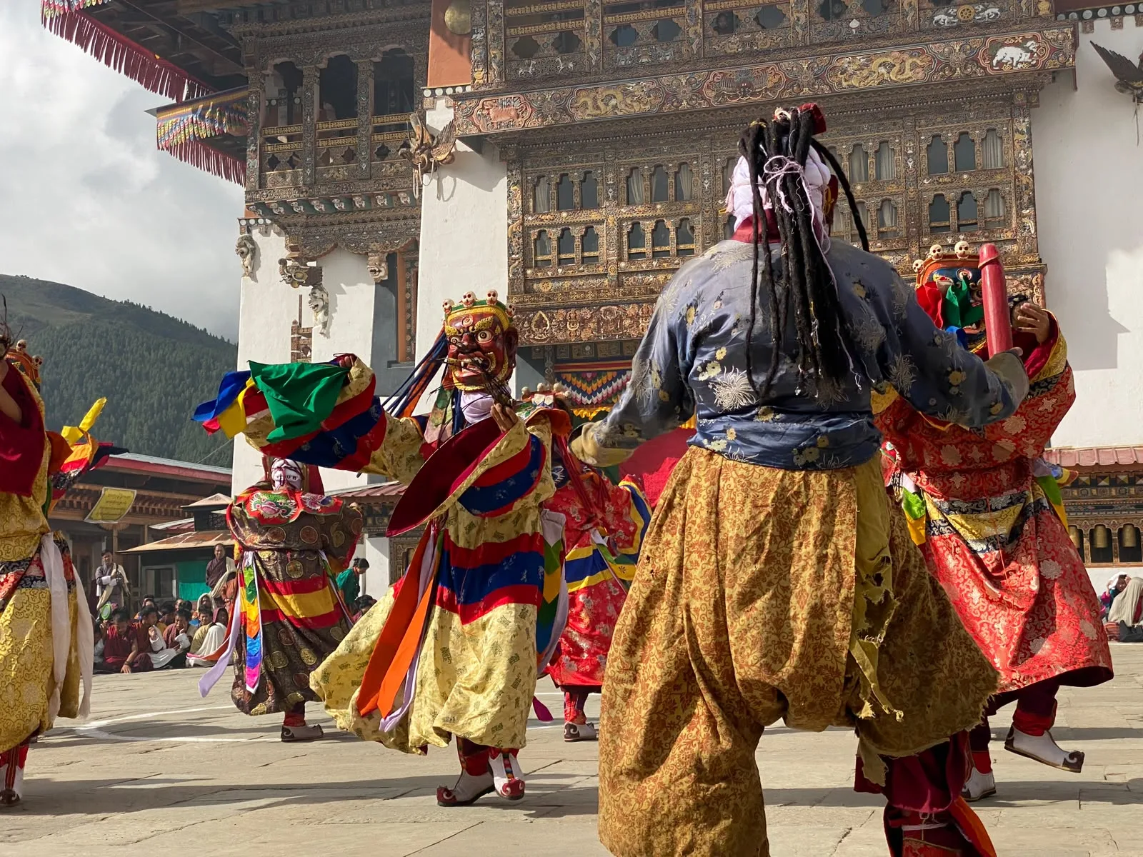 Masked dancers performing at a Bhutanese cultural festival