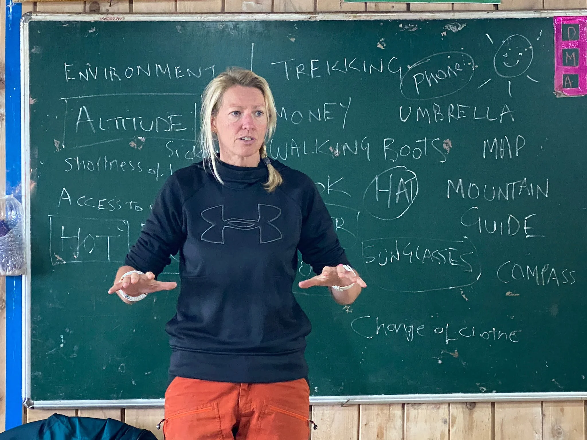 An expedition educator leading a mountain preparation session in a Bhutanese classroom